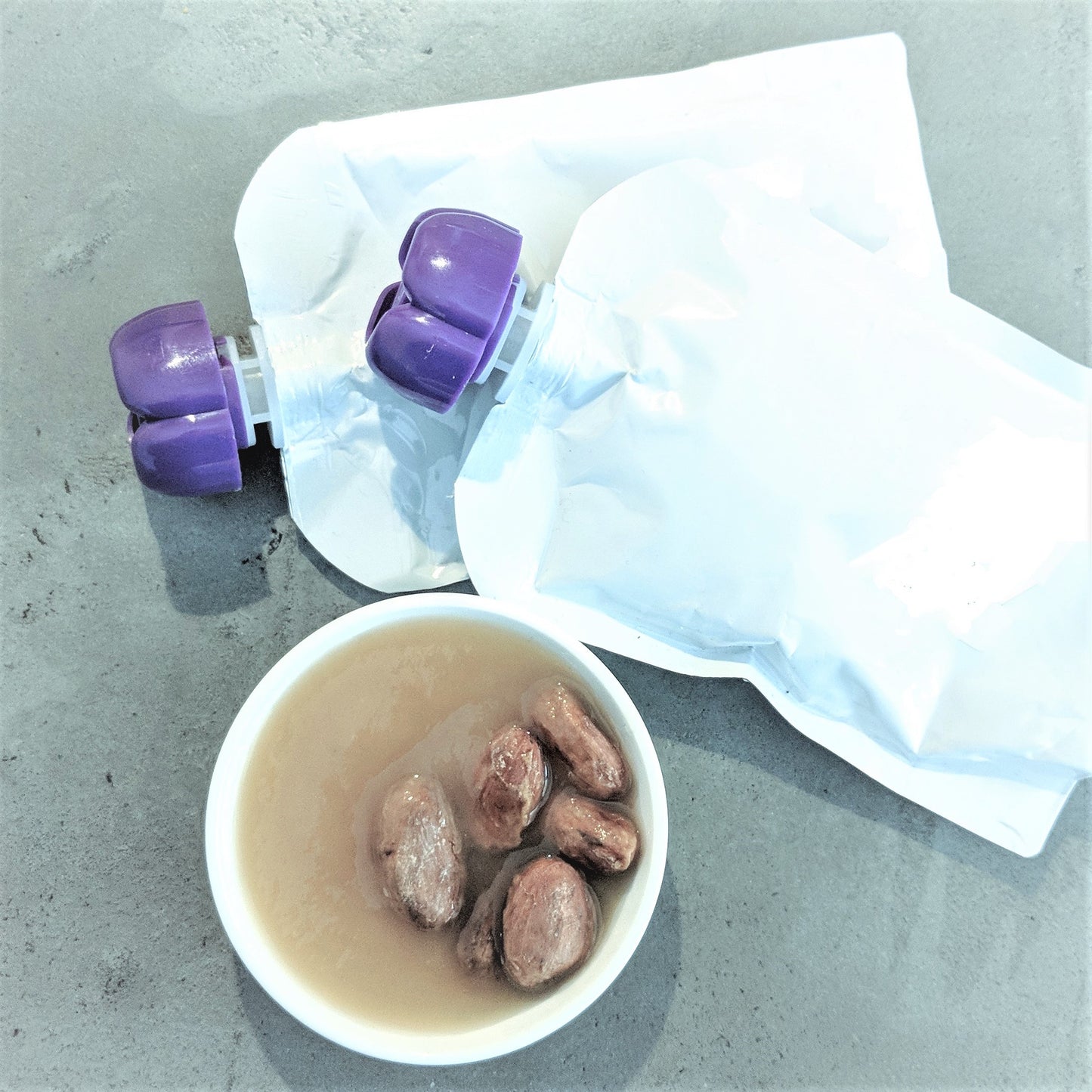 Cacao Nectar from pulp in pouches and on dish with beans