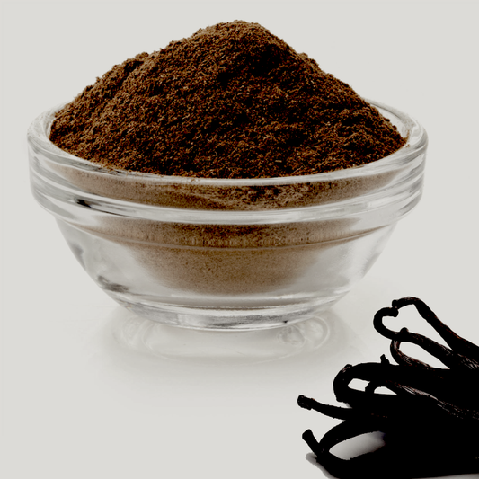 ground vanilla beans in glass dish with whole beans 