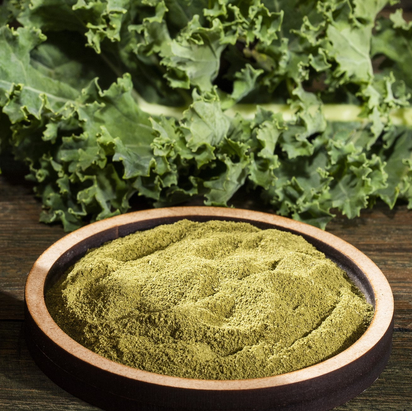 kale powder on a  dish with leaves in the back