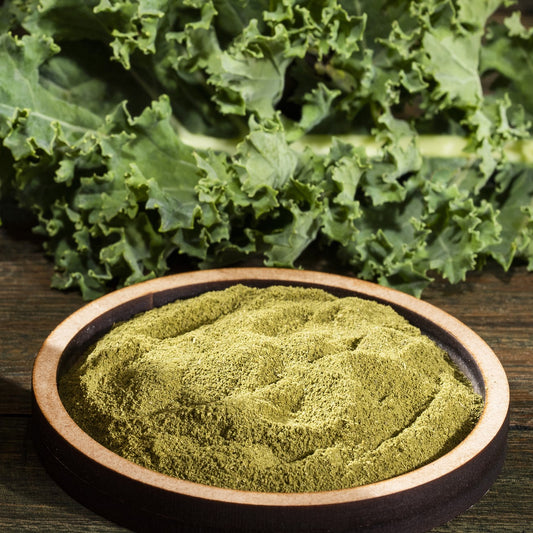 kale powder on a  dish with leaves in the back