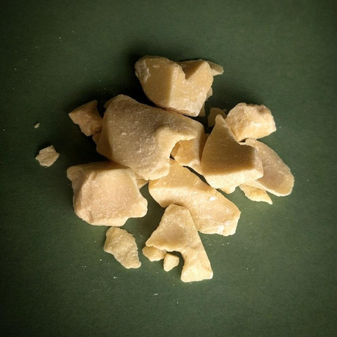 cocoa cacao butter chunks over green surface